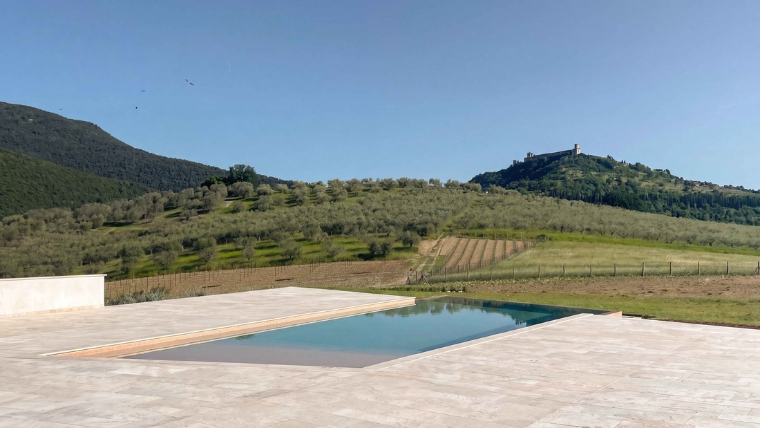 Travertine terrace and pool facing the Rocca Maggiore of Assisi